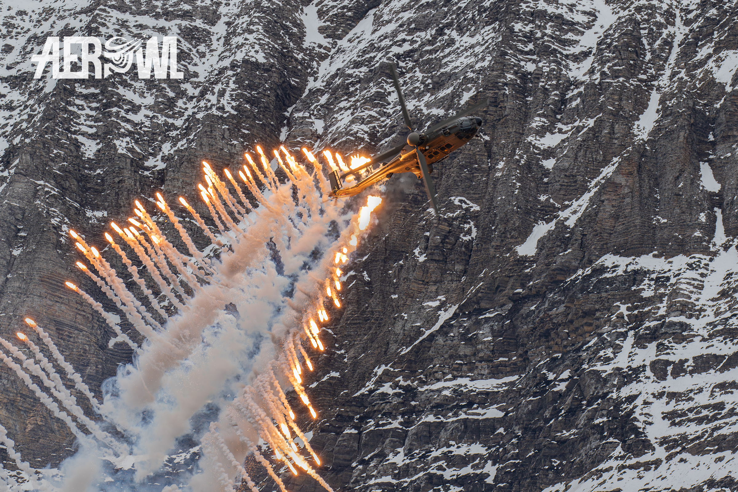 A Swiss Air Force Aerospatiale AS332M1 Super Cougar (T-339) deploys flares during the Axalp Fliegerschiessen 2018 near Brienz in Switzerland.