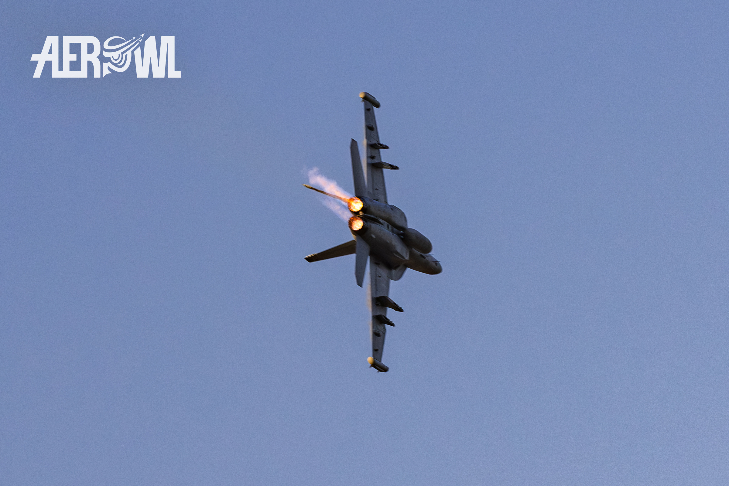 A Boeing EA-18 Growler (F/A-18F Hornet) pulling hard Gs with afterburner at the evening air display during the Sun´n Fun 2025 in Lakeland, Florida.