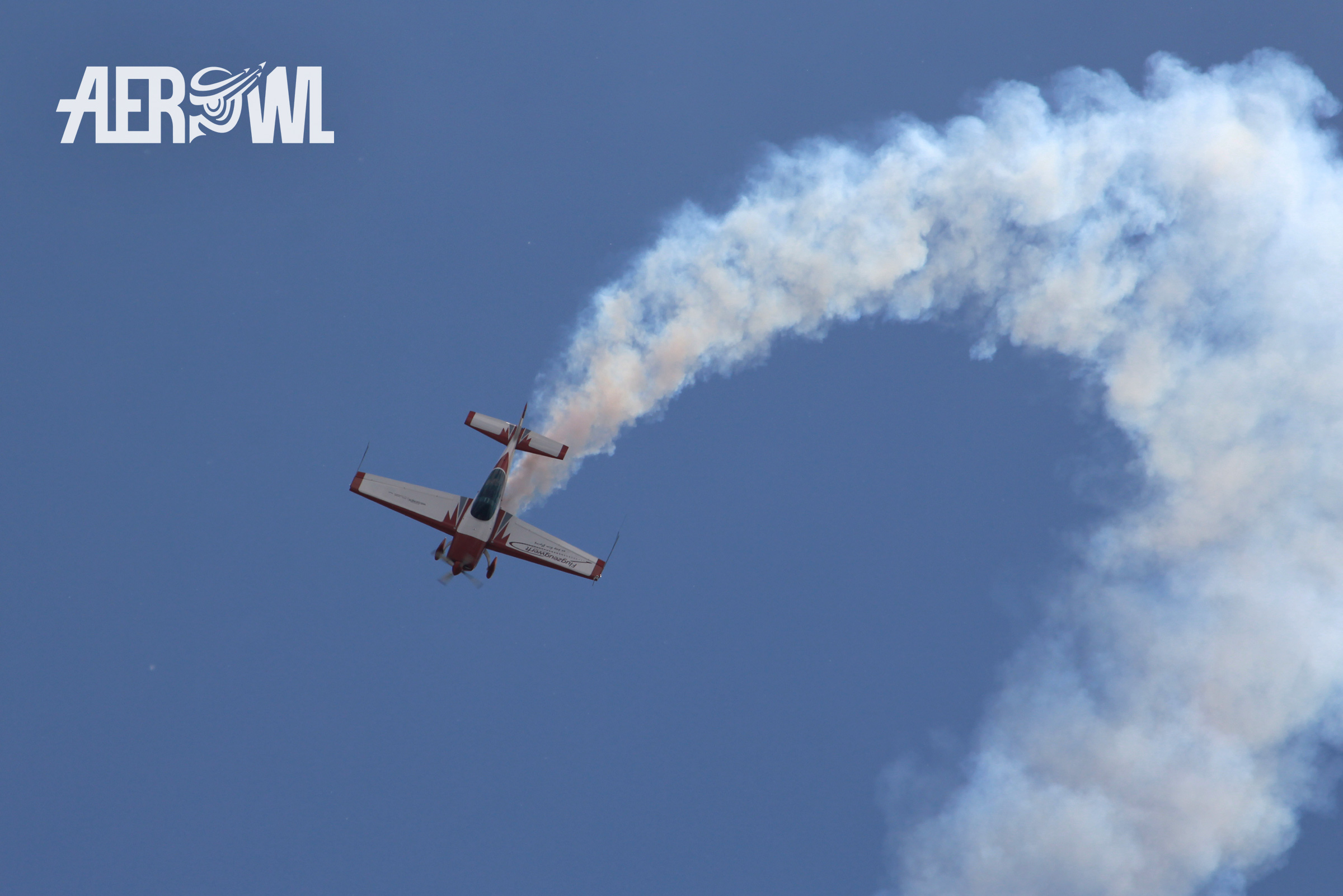 Pilot Uwe Wendt starts a legendary dive after a high climb in his Extra-300L over the BER airport during the ILA 2014 in Berlin/Brandenburg,