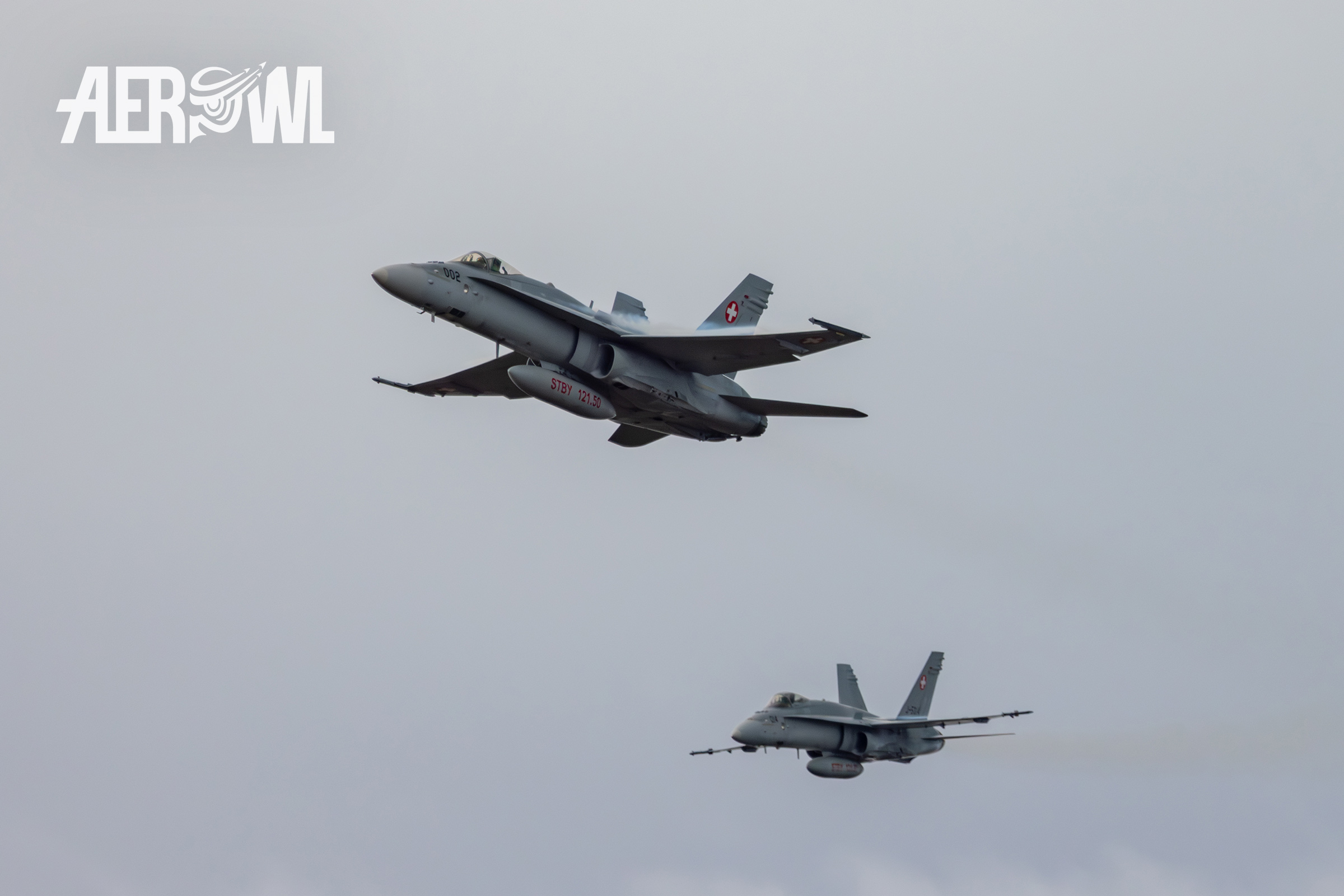 Two Swiss Air Force Boeing F/A-18C Hornets take off after firing their 20mm M61 cannons at the Axalp 2023 air show in the Swiss Alps.