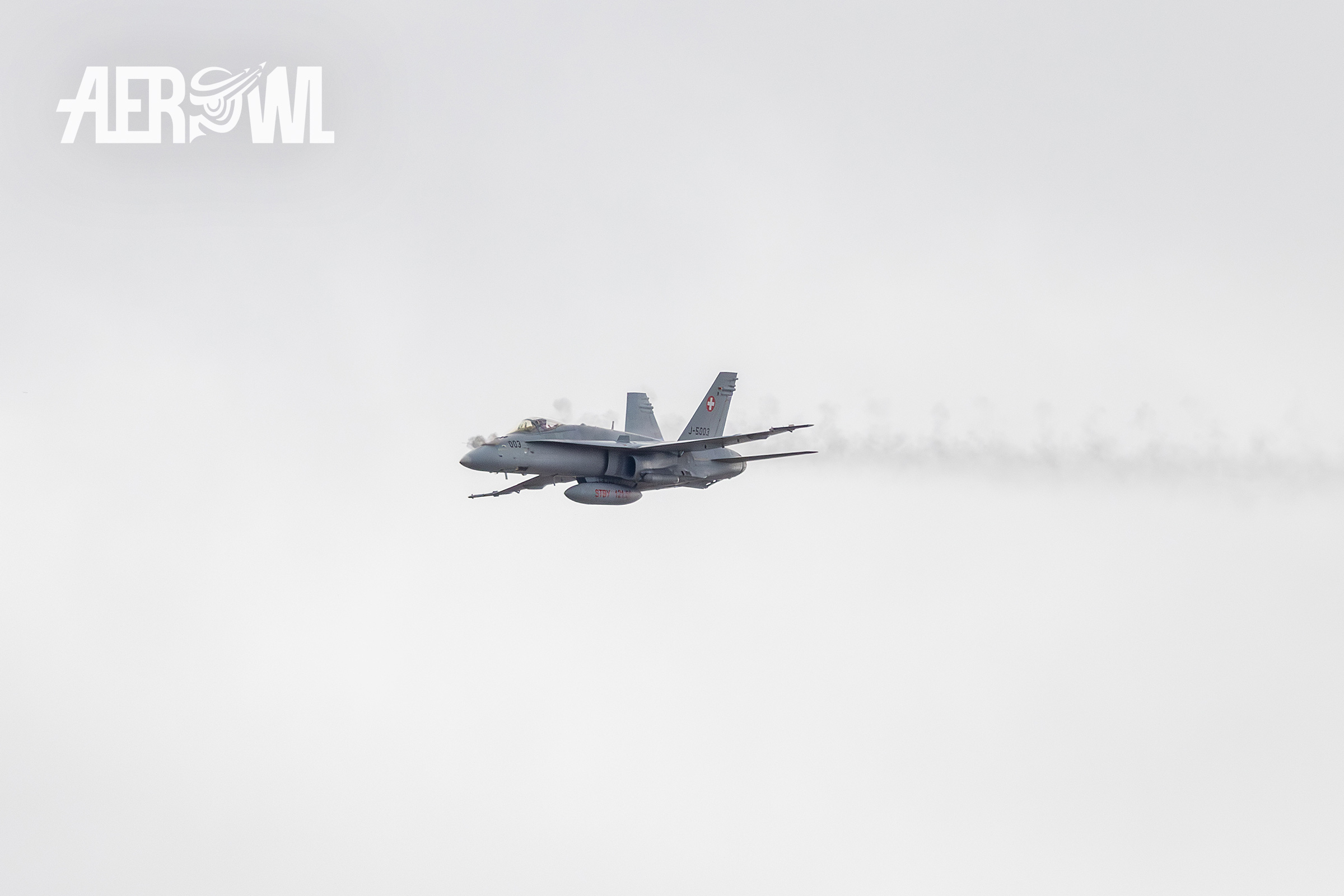 A Boeing F/A-18C Hornet of the Swiss Air Force fires its 20mm cannon during the Axalp Fliegerschiessen 2023 (Air Shoot display) in the Swiss Alps.
