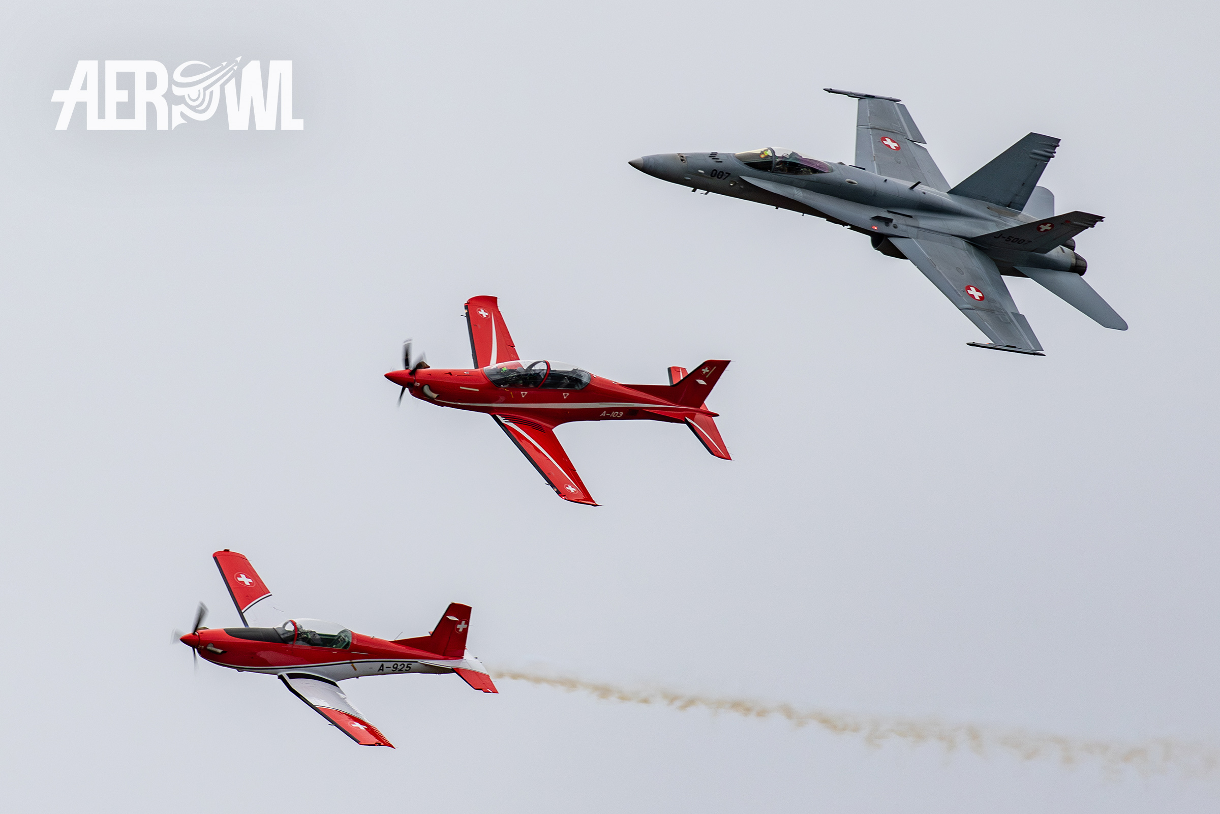 A F/A-18C Hornet, a PC-21 and a PC-7 fly together in a mixed air dispay to the Axalp 2018 in the Swiss mountains.