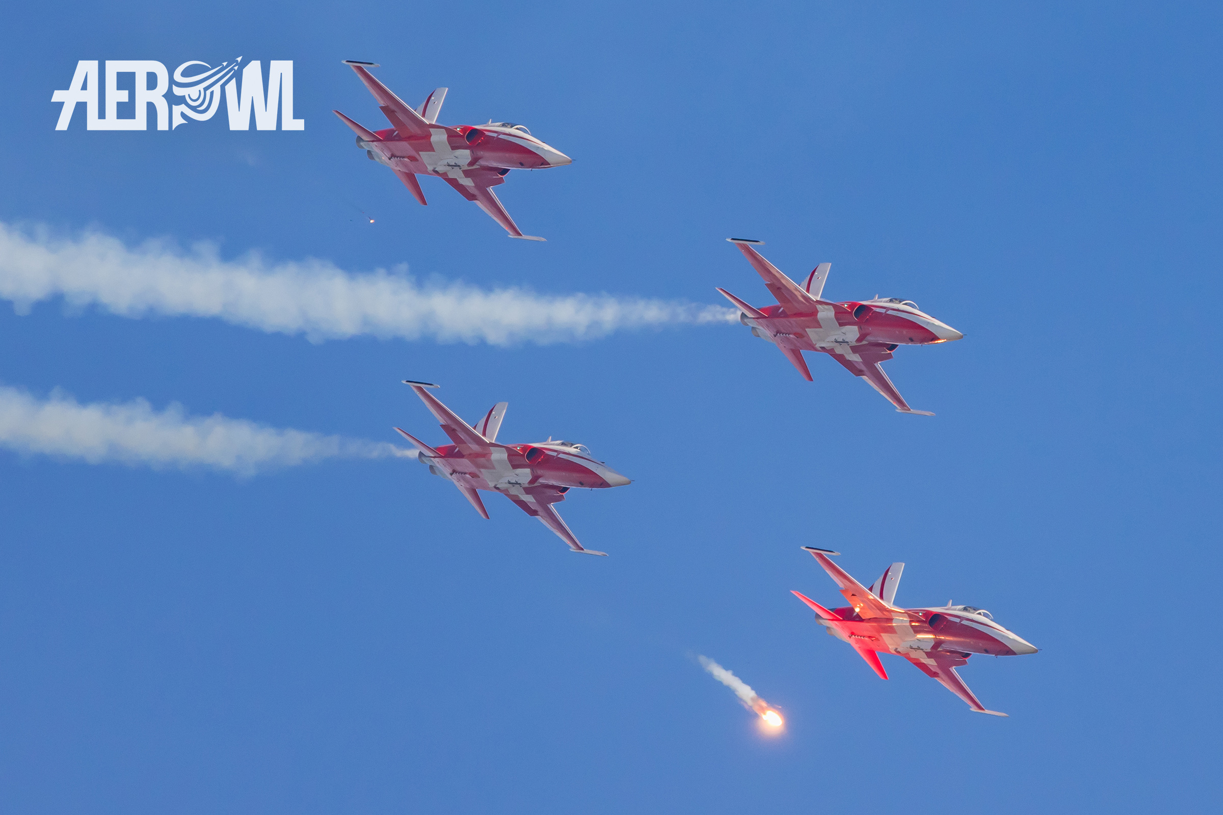 The Patrouille Suisse in their Northrop F-5E Tiger II dropping hot and bright flares during the Axalp 2022 airshow in the Swiss mountains.