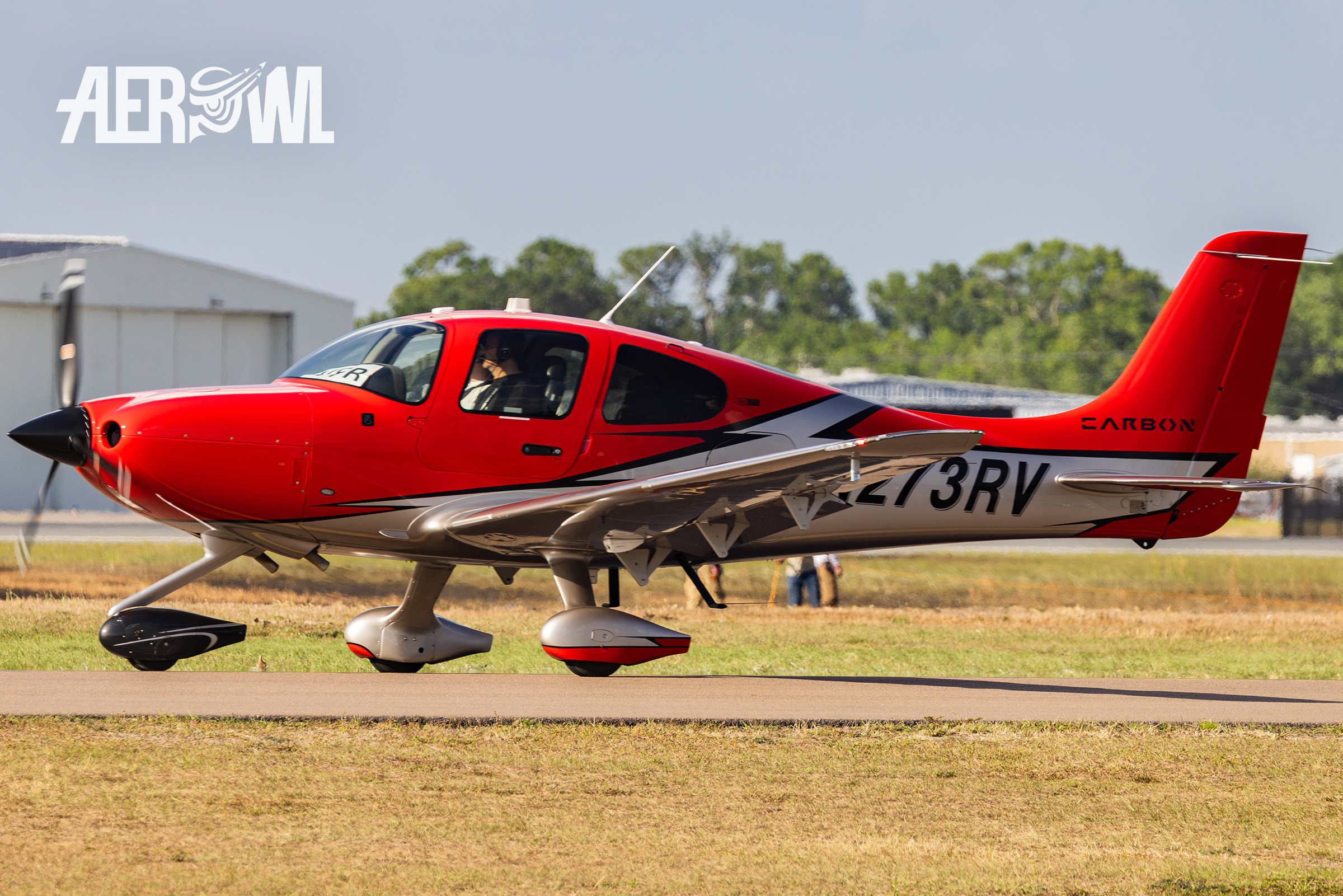 A red "carbon" Cirrus Design Corp SR22T on its way to the runway during the Sun´n Fun 2025 in Lakeland, Florida.