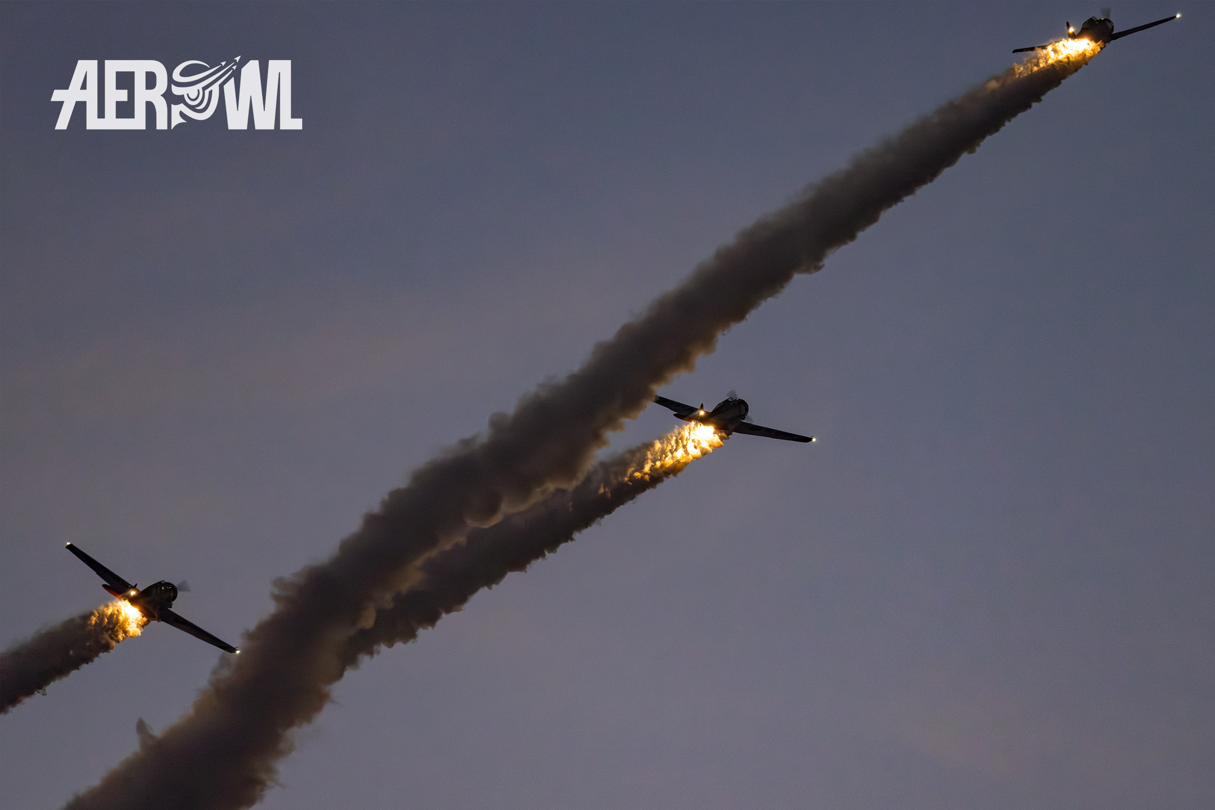 The Titan Aerobatic Team - North American AT-6 "Texan" smoking during the evening air display at the Sun´n Fun 2025 in Lankeland, Florida.