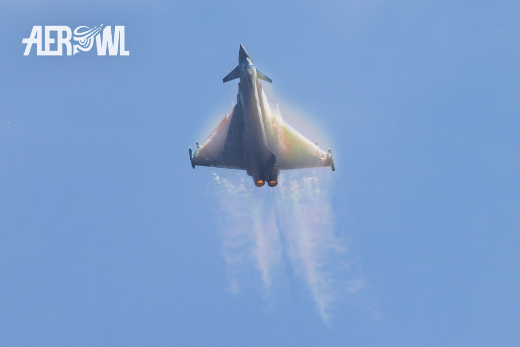 A Eurofighter Typhoon performing a hard pull-up over the runway, creating a rainbow, at the 73rd Tactical Air Force Wing base during its air show at the Tag der Bundeswehr 2026 in Laage, Germany.