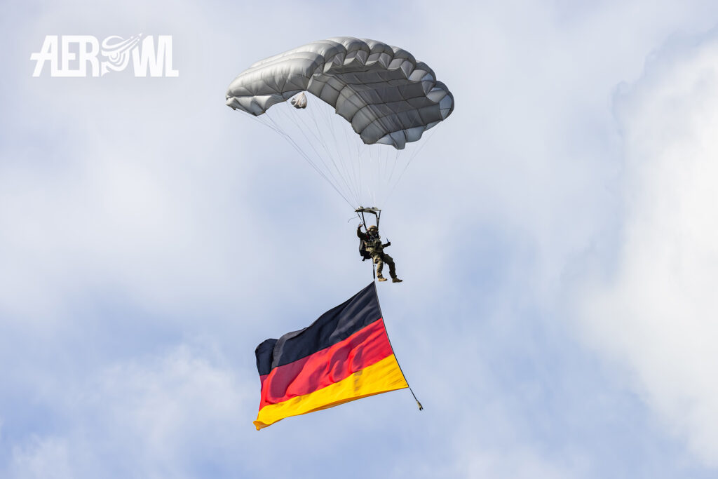 A group of paratroopers from the Special Forces Command just jumped out of a CH-53 and are now gliding toward the flight line during the Tag der Bundeswehr 2026 at the Fliegerhorst Laage in Germany.