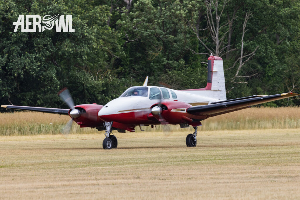 A classic painted Beechcraft E50 Twin Bonanza "N773AG" touch down at the Bienenfarm in Brandenburg during the Stearman & Friends 2026.