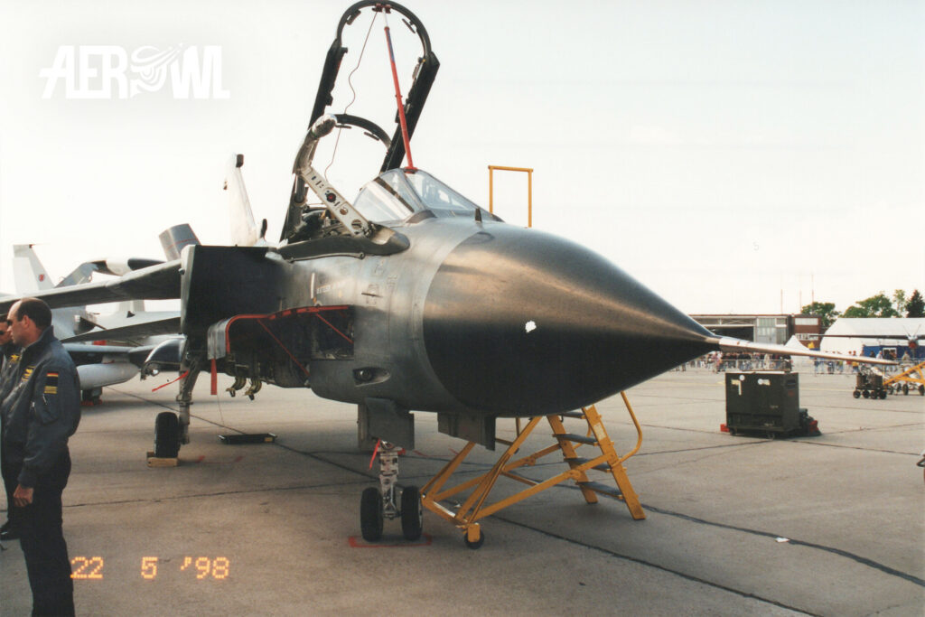 A German Air Force Tornado IDS with its cockpit and access panels open on static display, while the crew answers visitors’ questions during ILA 1998 in Berlin-Schönefeld.